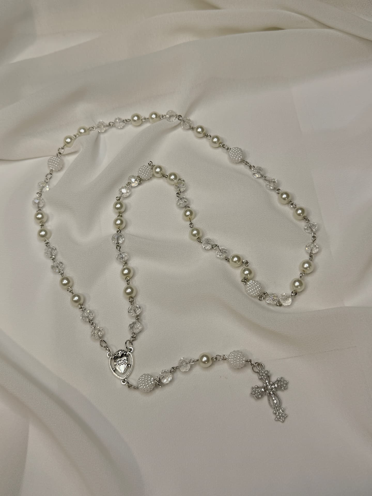 Crystal white pearl full rosary with Sacred Heart centerpiece and silver crucifix on white satin